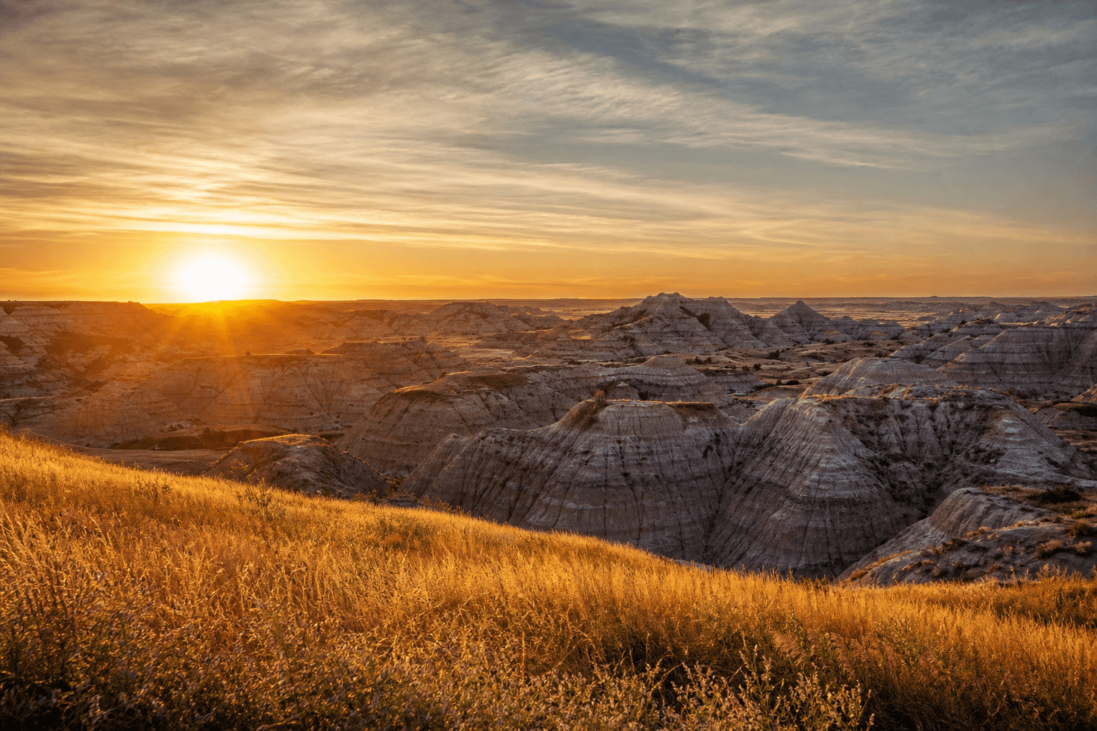 North Dakota Badlands at sunrise with golden light on dramatic butte formations