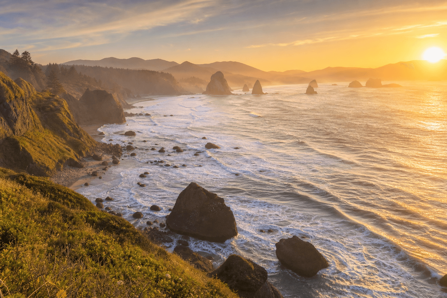 Oregon coastline at sunset with dramatic Pacific sea stacks and golden light