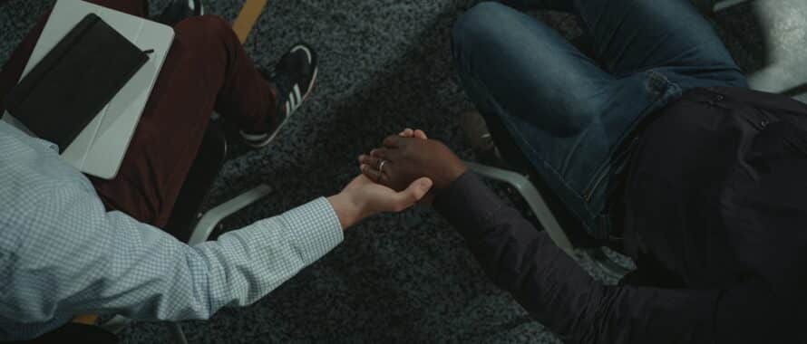 holding hands in a meeting